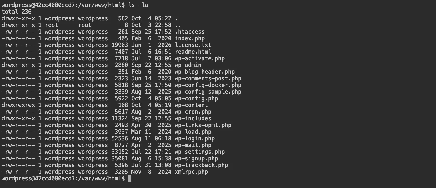 Terminal output of ls -la in the WordPress root folder, showing wp-config.php next to .htaccess, index.php, wp-admin, wp-content and wp-includes